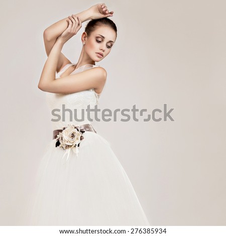 Beautiful girl model in the form of a bride in her wedding dress. Beauty face. Picture taken in the studio on a white background.