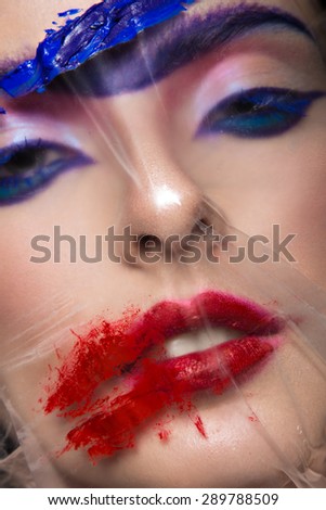 Fashion model with bright make-up art with a solid eyebrow. Creative image. Picture taken in the studio.