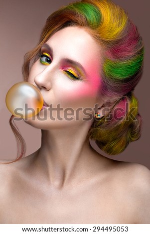 Fashion Girl with colored face and hair painted. Art beauty image.