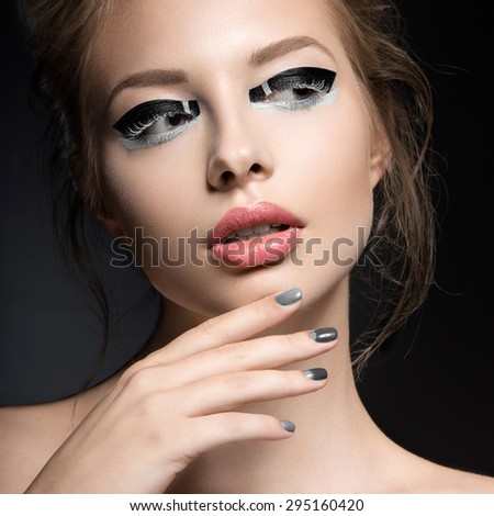 Beautiful girl with bright creative fashion makeup and Grey nail polish. Art beauty design.