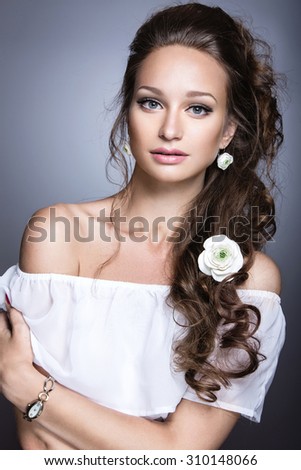 Portrait of a beautiful girl with flowers on her hair. Beauty face. Wedding image in the style boho