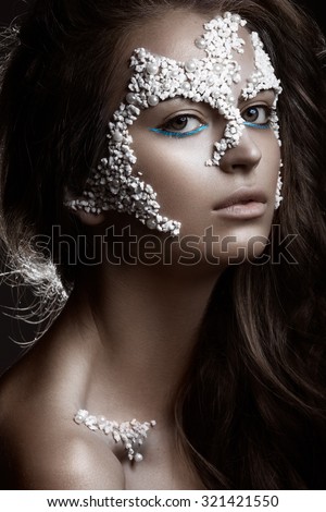 Beautiful dark-haired girl with a fashionable creative makeup. Beauty face. Art image.