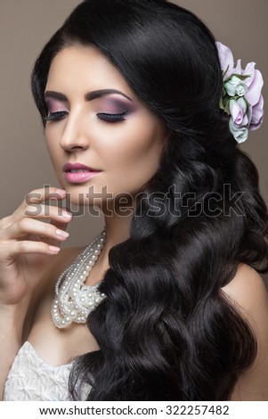 Beautiful brunette woman in image of the bride with flowers. Beauty face and Hairstyle