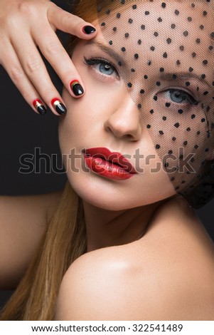 Beautiful girl with a veil, evening makeup, black and red nails. Design manicure. Beauty face.