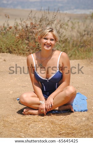 blond woman sitting in the sun laughing