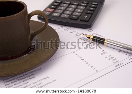 Finances and balances with pen, coffee and calculator