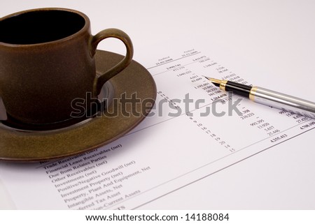 Finances and balances with pen and coffee