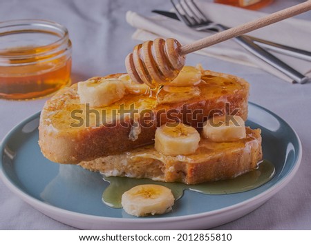 Similar – Image, Stock Photo Honey pouring over fried toasts with fruit