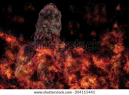 Sack ghost Fear and Halloween Theme: creepy killer in a mask fire on a dark background,Halloween theme