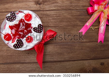 Cake decorated with frosting and cherries\'s birthday on the old wooden floor.