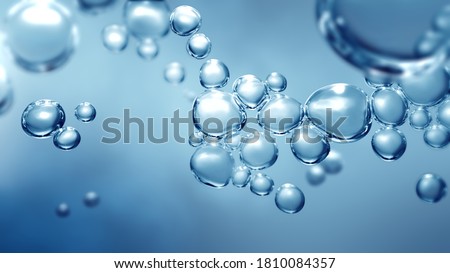 Bubbling fizz and refreshing beauty care products cleanliness or reviving vitality. Studio shot of transparent effervescent blue gas bubbles levitating in macroscopic view with defocus bokeh blur.