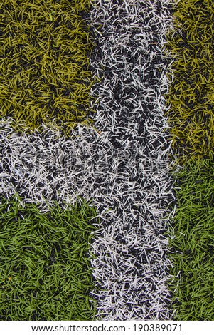 Green and yellow artificial turf pattern with a line