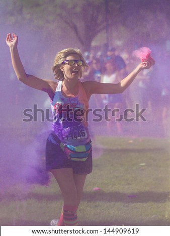 BOISE, IDAHO/USA - JUNE 22: Runner 13446 just got color bombed at the Color Me Rad 5k in boise on June 22, 2013