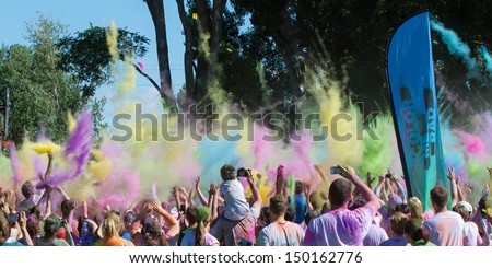 BOISE, IDAHO/USA - JUNE 22: The crowd throws up their color bombs into the air during the Color Me Rad 5k in Boise, Idaho on June 22, 2013