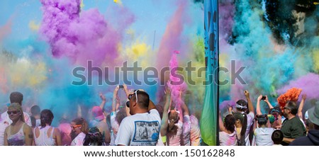 BOISE, IDAHO/USA - JUNE 22: Color bombs are being thrown into the air by the crowd at the Color Me Rad 5k in Boise, Idaho on June 22, 2013