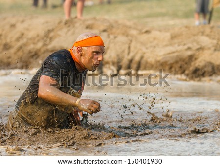 BOISE, IDAHO/USA - AUGUST 10:A man who is unidentified participates by running through the mud pit  at the The Dirty Dash in Boise, Idaho on August 10, 2013