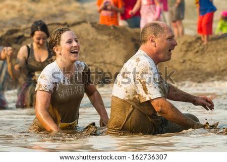 BOISE, IDAHO/USA - AUGUST 10: Two unidentified people make their way through the mud pit at the The Dirty Dash in Boise, Idaho on August 10, 2013
