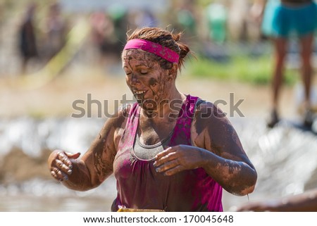 BOISE, IDAHO/USA - AUGUST 10, 2013: Unidentified woman covered in mud near the end of the race at the The Dirty Dash