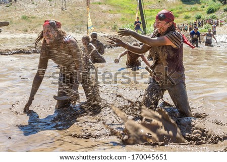 BOISE, IDAHO/USA - AUGUST 10, 2013: Two women splash each other with mud at the The Dirty Dash