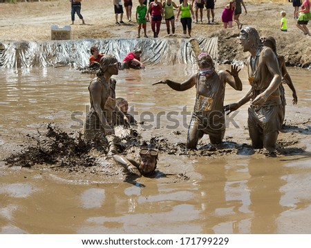 BOISE, IDAHO/USA - AUGUST 11, 2013: Group of people splashing at the end of the race at the dirty dash