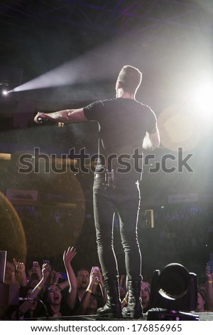 BOISE, IDAHO/USA - FEBRUARY 8, 2013: Dan Reynolds holds his microphone out to the crowd during his performance at the Imagine Dragons concert