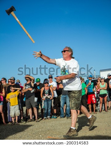 CASCADE, IDAHO/USA - JUNE 21, 2014: Unidentified man throwing an axe at a target at the Payette River Games
