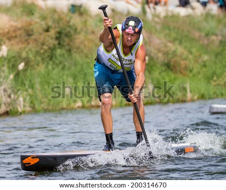 CASCADE, IDAHO/USA - JUNE 21, 2014: Focused on the finish line a SUP is near the end at the Payette River Games