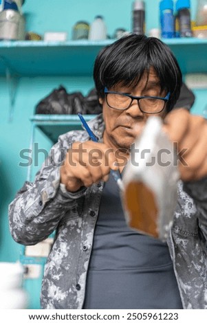 Similar – Image, Stock Photo Craftsman applying varnish to wood jalousie using airbrush in carpentry workshop