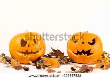 Halloween pumpkins with autumn leaves isolated on a white background with copy space for text. Scary faces concept