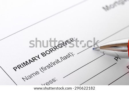 Mortgage application form close up with borrower information and pen. selective focus, shallow depth of field