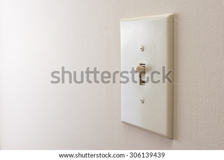 Classic light switch hanging on the wall