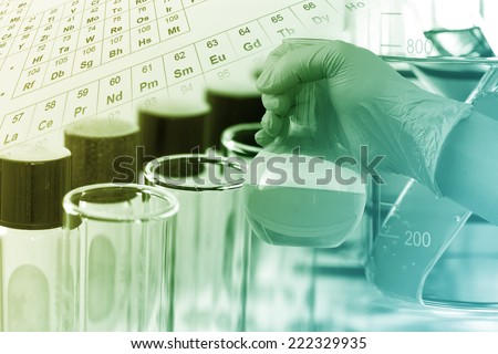 gloved hand hold the round bottom flask in laboratory room