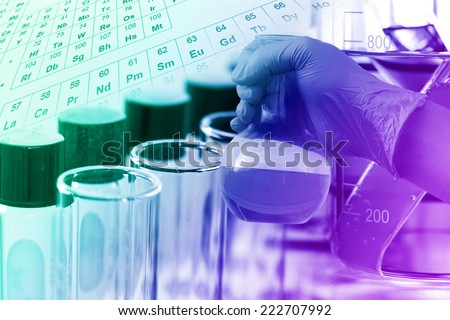 gloved hand hold the round bottom flask in laboratory room