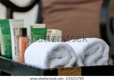 Hotel cosmetics kit and towel in basket