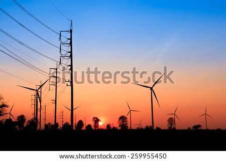 Wind turbine power generator silhouette at sunset