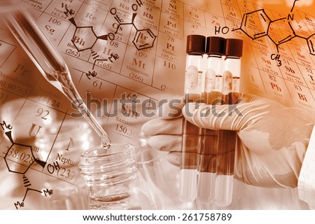 Researcher\'s gloved hand holding the test tubes with periodic table and chemical structure background at laboratory