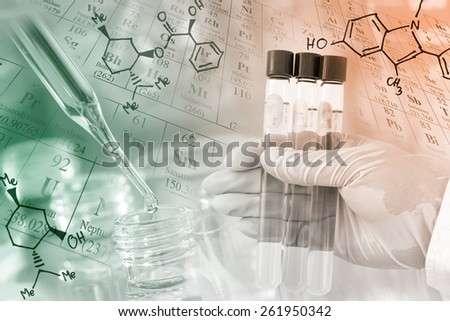 Researcher\'s gloved hand holding the test tubes with periodic table and chemical structure background at laboratory