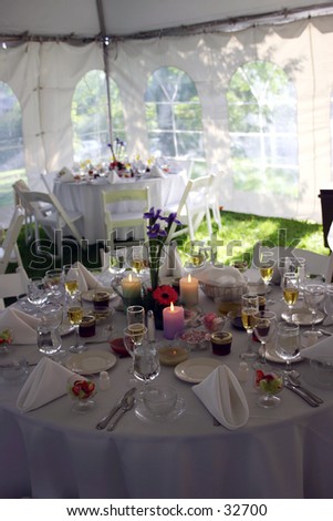 Tables set up in a tent at a wedding