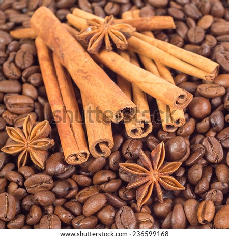 Lots of coffee beans. Three anise stars, lots of sticks of cinnamon. Shallow depth of field.