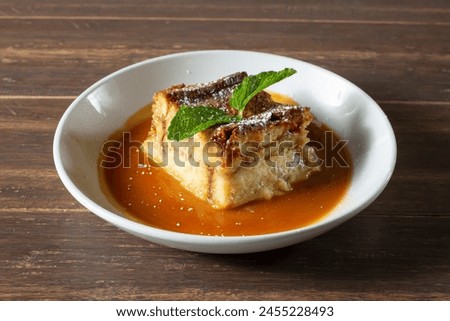 Similar – Image, Stock Photo Sweet bread pudding with orange zest butter