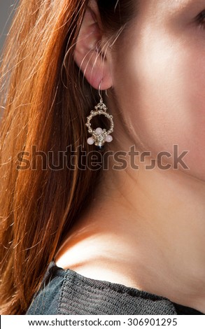 jewelry, women\'s jewelry made with his own hands, a young girl with ornaments is photographed in the studio, handmade, women\'s jewelry