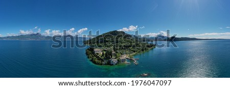 Panorama of punta san vigilio.  Aerial view of Parco Baia delle Sirene, Lake Garda, Italy. Top view of baia delle sirene on the coastline of Lake Garda. Baia delle Sirene on the coastline.