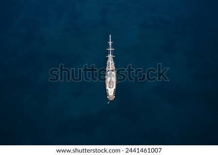 Similar – Foto Bild Segelyacht vor Anker in einer Bucht, durch Blätter einer Agave im Vordergrund gesehen, die ein Muster bilden