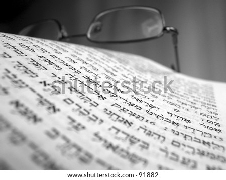 the bible and glasses macro photo of the hebrew letters\
\
\
\
\
\
black and white