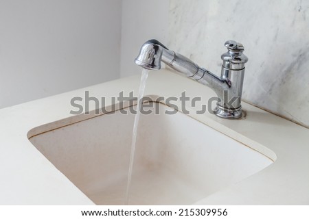 Water drop from faucet white modern white sink