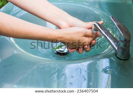 washing hand and turn off faucet out door