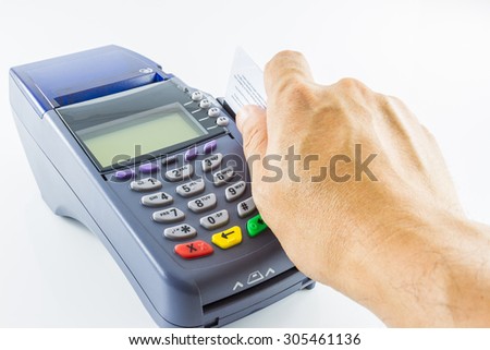 hand holding a credit card with credit card machine isolated on white background