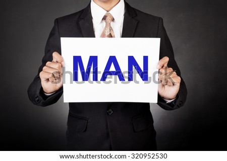A business man holding a paper in front of his face:man concept
