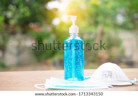 Alcohol hand gel for hand hygiene surgical mask N95 COVID-19 corona virus and bacterial protection. Surgical mask, N95 and alcohol hand gel for COVID-19 coronavirus prevention. Stock foto © 