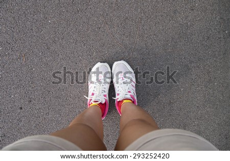 Sporty woman feet on a race track . Preparing for run.